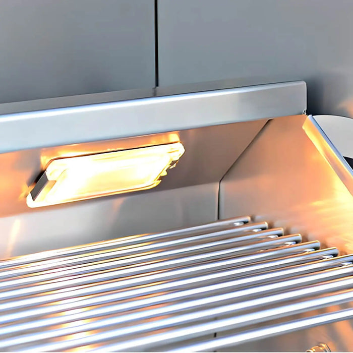 Metallic grill with glowing heating element inside a kitchen hood